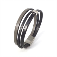 Pulsera de hombre multieslabones de piel negra y gris topo con trabilla de metal