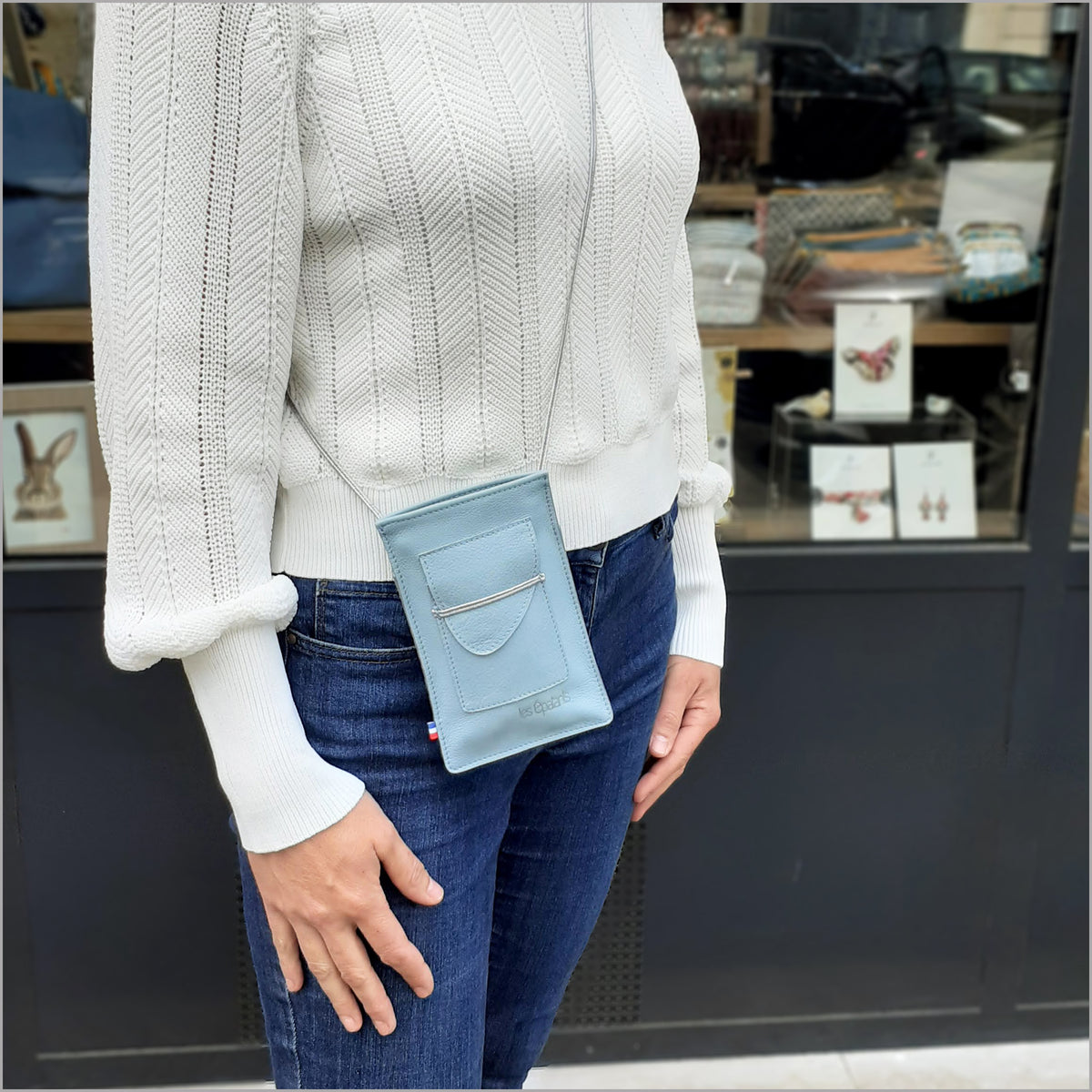 Sky blue leather portable pouch with adjustable shoulder strap