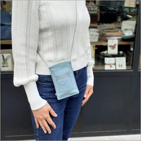 Sky blue leather portable pouch with adjustable shoulder strap